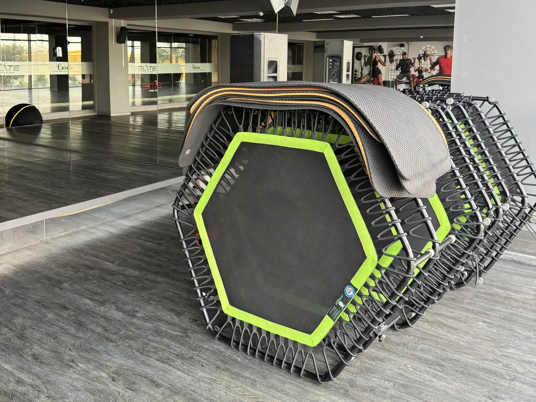 Trampolines hexagonaux à bordure vert fluo empilés dans le studio